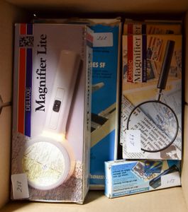 Various items, including 3 magnifying glasses, 2 UV lights and 1 cutting table